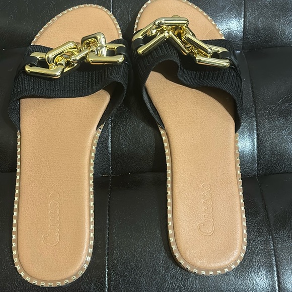 Black and gold slides in size 11. Gold buckle at the top and gold design around - Picture 1 of 4